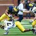 Michigan fullback Sione Houma attempts to carry the ball around defensive back Ross Douglas during spring practice at Michigan Stadium on Saturday, April 13, 2013. Melanie Maxwell I AnnArbor.com